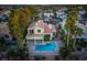 An aerial view of a two-story home featuring a backyard pool and desert landscaping at 2104 Inverness Dr, Henderson, NV 89074