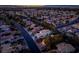 An aerial shot shows single-Gathering homes in a residential area with lush trees at dusk at 2104 Inverness Dr, Henderson, NV 89074