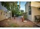 Landscaped backyard with decorative elements and mature trees and plants, a tranquil outdoor setting at 2104 Inverness Dr, Henderson, NV 89074