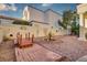 Well-maintained backyard with a small bridge, desert landscaping, and unique wall decor at 2104 Inverness Dr, Henderson, NV 89074