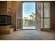 View through open louvered doors to a balcony with foliage at 2104 Inverness Dr, Henderson, NV 89074