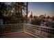 An open-air tiled balcony offers views of mature trees and charming single-Gathering homes in a well-maintained community at 2104 Inverness Dr, Henderson, NV 89074