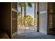 Balcony view with palm trees and a fenced railing, accessible from the interior of the home at 2104 Inverness Dr, Henderson, NV 89074