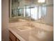 Bathroom featuring vanity with tan tile countertop and mirrored backsplash at 2104 Inverness Dr, Henderson, NV 89074