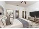 Bright bedroom featuring decor, an entertainment center, and a doorway to the bathroom at 2104 Inverness Dr, Henderson, NV 89074