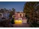 Attractive two-story home with a red tile roof and a well-manicured front yard, shot at dusk at 2104 Inverness Dr, Henderson, NV 89074