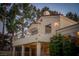 Exterior view showcasing a balcony, pillars, and a meticulously landscaped yard at 2104 Inverness Dr, Henderson, NV 89074
