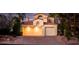 Charming home features a three-car garage, a red-brick driveway and manicured landscaping at 2104 Inverness Dr, Henderson, NV 89074