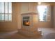 Living room features a beautiful fireplace, plush carpet, and natural light from the large windows at 2104 Inverness Dr, Henderson, NV 89074