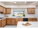 Corner kitchen with stainless steel sink, bright window, and butcherblock top island at 2104 Inverness Dr, Henderson, NV 89074