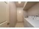 Laundry room with door to the backyard and side-by-side washer and dryer at 2104 Inverness Dr, Henderson, NV 89074