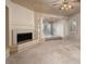 Open living room has fireplace, carpeted flooring, and pillars at 2104 Inverness Dr, Henderson, NV 89074