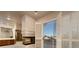 Bright living room features a tiled fireplace and access to a balcony with louvered doors at 2104 Inverness Dr, Henderson, NV 89074