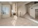 Open living room with fireplace, staircase, large windows with shutters, and neutral tones at 2104 Inverness Dr, Henderson, NV 89074