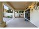 A covered patio featuring tiled flooring, decorative pillars, and access to a sliding glass door at 2104 Inverness Dr, Henderson, NV 89074
