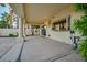 Spacious covered patio with pillars, outdoor lighting, and a view of the landscaped backyard at 2104 Inverness Dr, Henderson, NV 89074