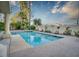 Beautiful pool with desert landscaping, and cacti along the back wall at 2104 Inverness Dr, Henderson, NV 89074