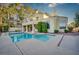 Back of house with a sparkling pool and mature landscaping at 2104 Inverness Dr, Henderson, NV 89074