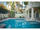 Sparkling pool with palm trees and landscaping reflected in the water at 2104 Inverness Dr, Henderson, NV 89074