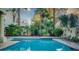 Inviting swimming pool with palm trees and lush greenery at 2104 Inverness Dr, Henderson, NV 89074