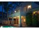 A covered patio provides shade beside the pool, accented by lush landscaping and architectural details at 2104 Inverness Dr, Henderson, NV 89074