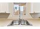 Modern double basin kitchen sink with a view of exterior stairs and desert landscaping at 2232 Aspen Mirror Way # 103, Laughlin, NV 89029