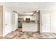A kitchen with stainless steel appliances, white cabinets, tile floors and a breakfast bar at 2232 Aspen Mirror Way # 103, Laughlin, NV 89029