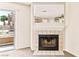 Living room with a fireplace, neutral carpet, and sliding glass door to a balcony area at 2232 Aspen Mirror Way # 103, Laughlin, NV 89029