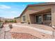 Landscaped backyard featuring decorative rock, patio, covered terrace, and mature plants at 2243 Albury Ave, North Las Vegas, NV 89086