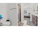 Bright bathroom features a glass enclosed shower, toilet and adjacent bedroom at 2243 Albury Ave, North Las Vegas, NV 89086