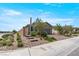 Single story home with brick paved driveway, desert landscaping, and a privacy wall at 2243 Albury Ave, North Las Vegas, NV 89086