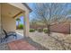 Private backyard with low-maintenance desert landscaping, covered patio, and charming brick wall at 2409 Garganey Ave, North Las Vegas, NV 89084