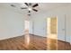 Spacious bedroom with wood floors and a ceiling fan with two open doorways at 2409 Garganey Ave, North Las Vegas, NV 89084