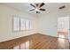 Spacious bedroom with wood floors, plantation shutters, and a ceiling fan at 2409 Garganey Ave, North Las Vegas, NV 89084