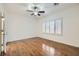 Spacious bedroom featuring wood flooring and a window with white shutters at 2409 Garganey Ave, North Las Vegas, NV 89084