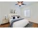 Bright bedroom featuring a ceiling fan, wood floors, and a neutral color scheme at 2409 Garganey Ave, North Las Vegas, NV 89084