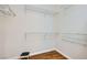 Walk-in closet with built-in shelving and wood-style flooring at 2409 Garganey Ave, North Las Vegas, NV 89084