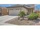 Well-maintained house showcasing desert landscaping and a two-car garage at 2409 Garganey Ave, North Las Vegas, NV 89084