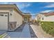 Home exterior features a decorative stone accent, well-manicured shrubs, and a quaint entryway at 2409 Garganey Ave, North Las Vegas, NV 89084