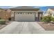 This home boasts a spacious garage with a concrete driveway, and desert landscaping at 2409 Garganey Ave, North Las Vegas, NV 89084