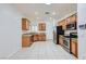 Well-lit kitchen featuring light wood cabinets, stainless steel appliances, and a functional layout at 2409 Garganey Ave, North Las Vegas, NV 89084