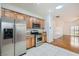 Open kitchen with light wood cabinets, stainless steel appliances, and tile floors provides a stylish cooking space at 2409 Garganey Ave, North Las Vegas, NV 89084