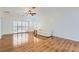 Open-concept living area with wood floors, sliding doors to backyard, and lots of natural light at 2409 Garganey Ave, North Las Vegas, NV 89084