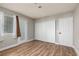 Bedroom with laminate wood flooring, closet, and natural light from window at 257 N Lamb Blvd # E, Las Vegas, NV 89110