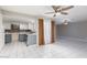 View of the updated kitchen and an airy living room with ceiling fans at 257 N Lamb Blvd # E, Las Vegas, NV 89110