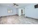 Spacious bedroom with wood-look tile flooring, ceiling fan, and natural light at 263 Baring Cross St, Henderson, NV 89074