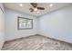 Cozy bedroom with wood-look tile flooring, ceiling fan, and ample natural light at 263 Baring Cross St, Henderson, NV 89074