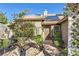 Inviting front entrance featuring a decorative door and lush, mature landscaping at 263 Baring Cross St, Henderson, NV 89074