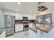 Bright kitchen with stainless steel appliances, white cabinetry and wood tile flooring at 263 Baring Cross St, Henderson, NV 89074