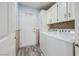 Functional laundry room featuring updated washer, dryer and convenient storage cabinets at 263 Baring Cross St, Henderson, NV 89074